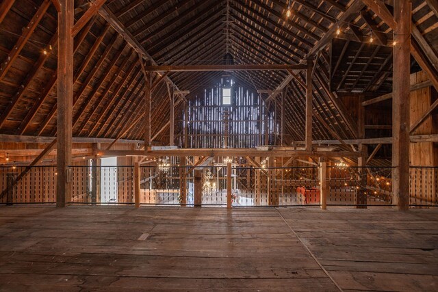 misc room with vaulted ceiling and hardwood / wood-style flooring