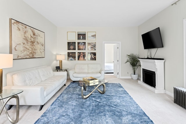 carpeted living room featuring radiator, a fireplace, and baseboards