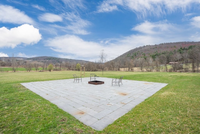 view of patio featuring a mountain view and a fire pit