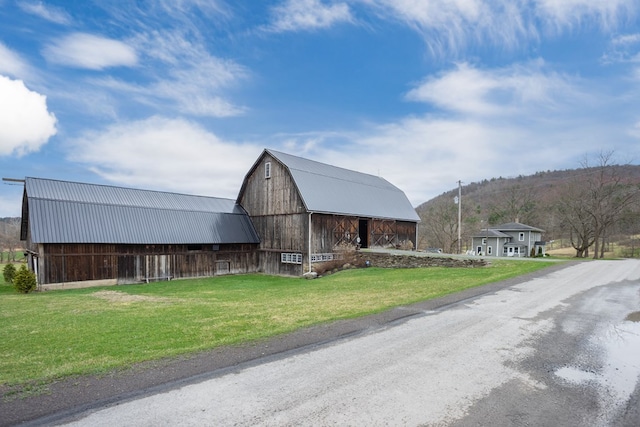 view of barn with a lawn