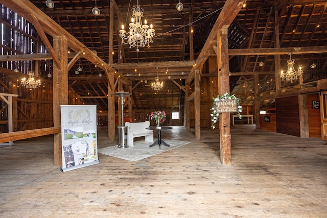 misc room featuring hardwood / wood-style floors and an inviting chandelier