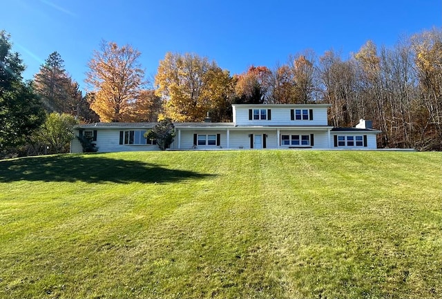 back of house featuring a lawn