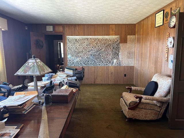 living area featuring a textured ceiling and wooden walls