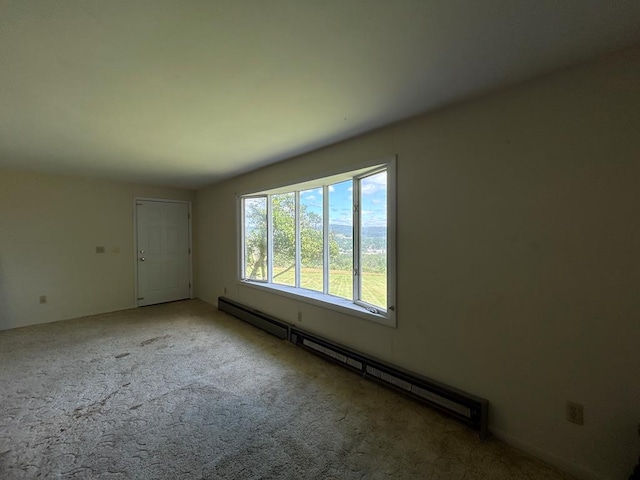 carpeted spare room with baseboard heating