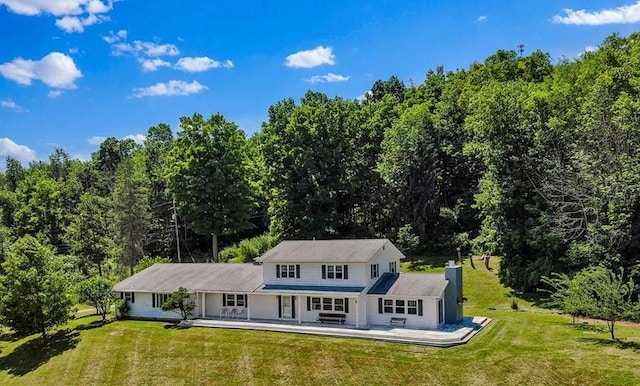 rear view of property with a yard