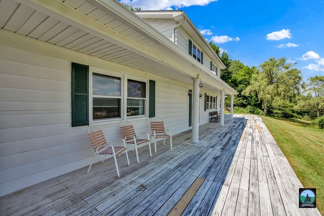 wooden terrace with a lawn