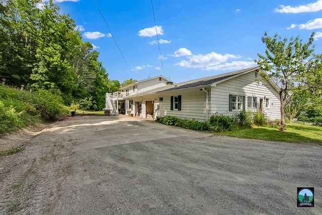 view of front of property featuring a carport