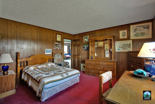 carpeted bedroom featuring wood walls and a textured ceiling