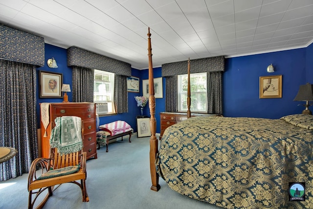 carpeted bedroom featuring multiple windows