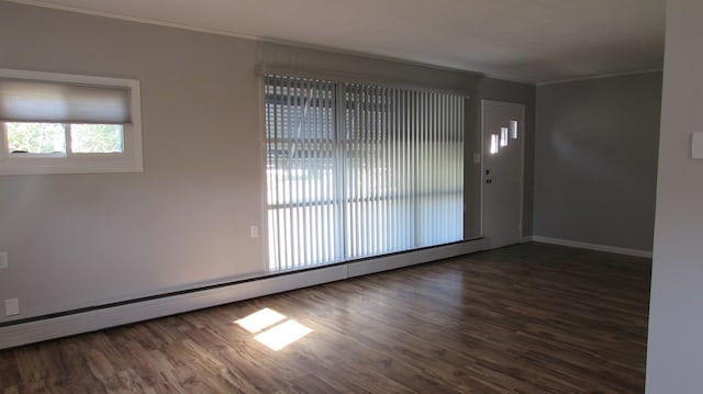 empty room with a baseboard radiator, dark hardwood / wood-style floors, and ornamental molding