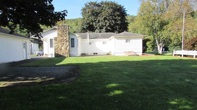 rear view of property featuring a yard