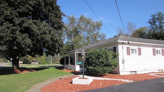 view of side of property with a lawn