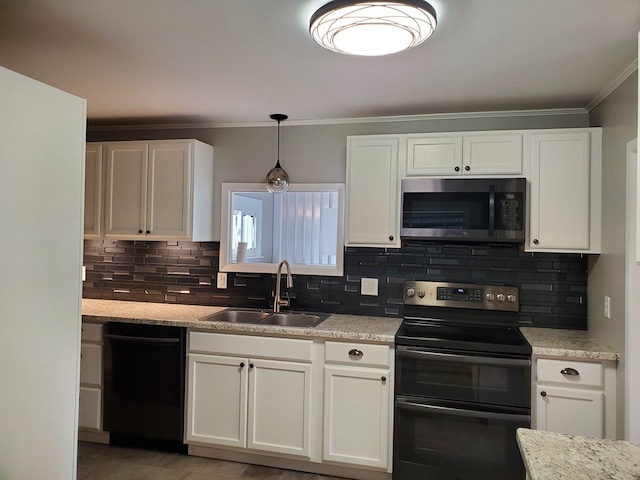 kitchen featuring light stone counters, stainless steel appliances, sink, white cabinets, and hanging light fixtures