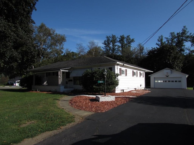 ranch-style home featuring an outbuilding, a front lawn, and a garage