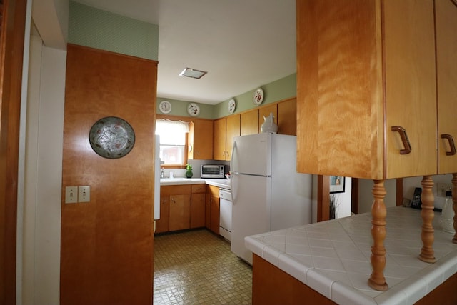 1 Mechanic St, Towanda, PA 18848 - kitchen with white appliances, tile countertops, brown cabinets, and light floors
