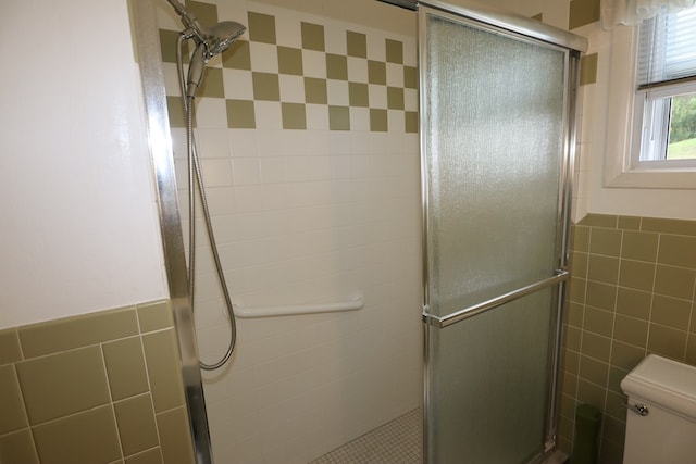 1 Mechanic St, Towanda, PA 18848 - bathroom with tile walls, a stall shower, and wainscoting