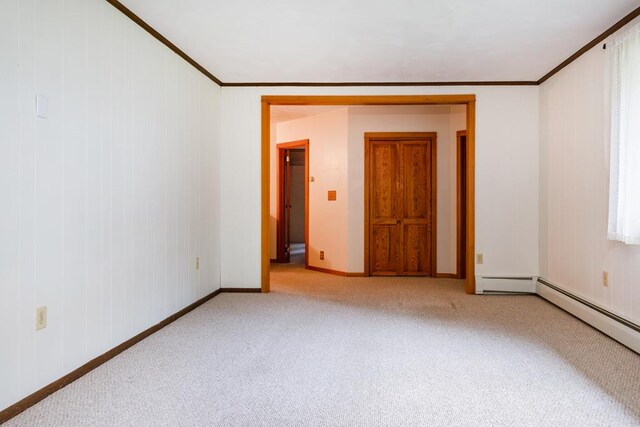 spare room featuring baseboards, carpet, and ornamental molding