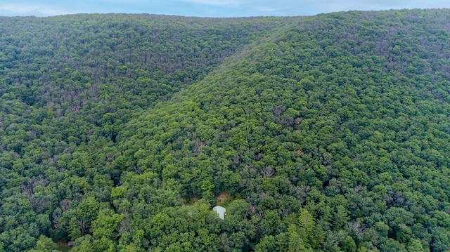 birds eye view of property featuring a view of trees