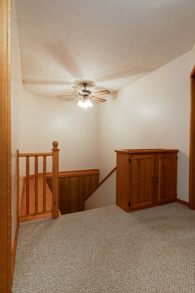 unfurnished room featuring light colored carpet and ceiling fan