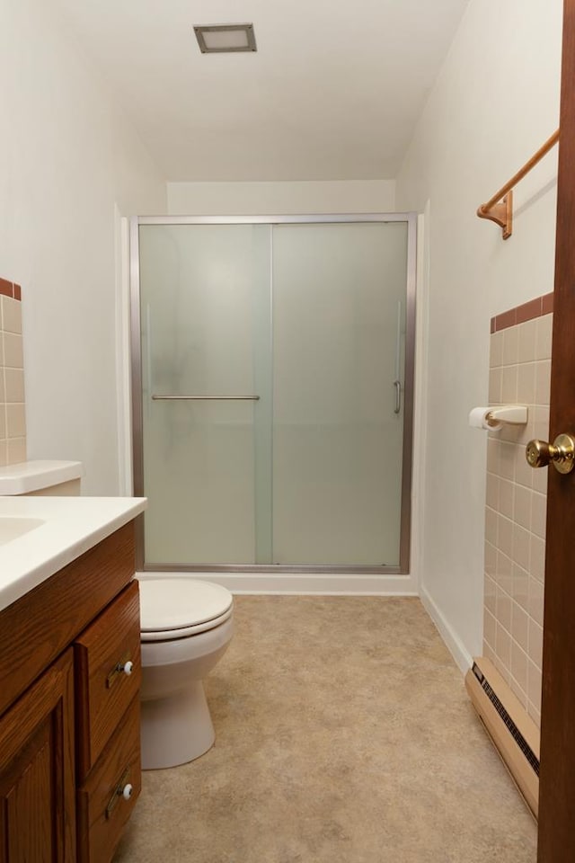 full bathroom featuring toilet, a stall shower, vanity, and a baseboard heating unit