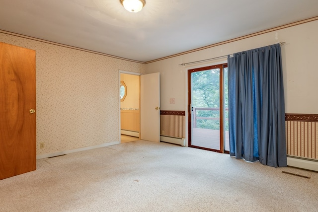 carpeted spare room with wainscoting, a baseboard heating unit, wallpapered walls, and crown molding