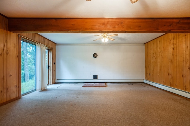 spare room with beamed ceiling, wooden walls, and carpet floors