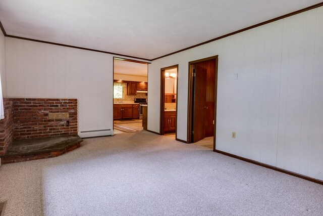 unfurnished living room featuring baseboards, light carpet, baseboard heating, and ornamental molding