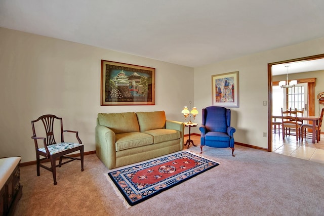 carpeted living room featuring baseboards and a chandelier