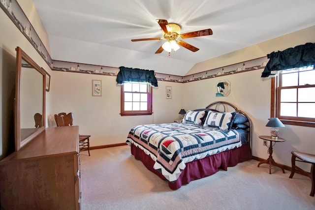 carpeted bedroom featuring vaulted ceiling, a ceiling fan, and baseboards