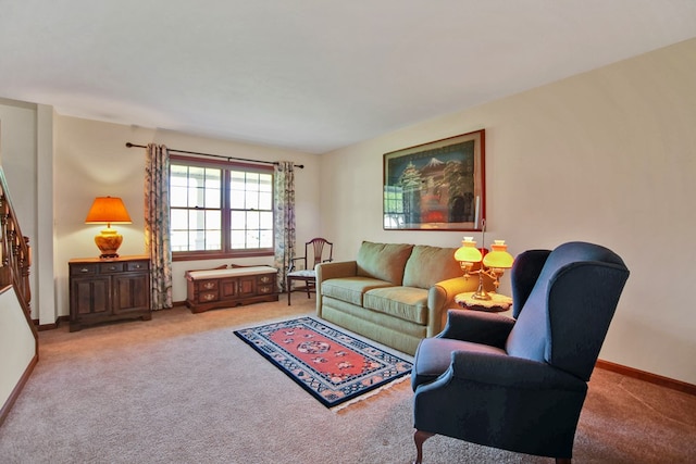 carpeted living area with baseboards