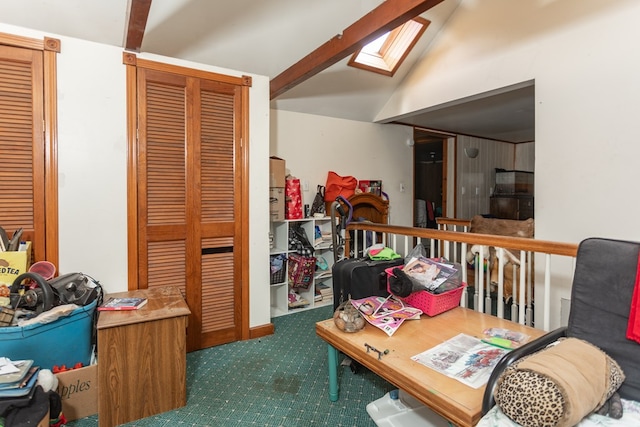 interior space featuring vaulted ceiling with skylight and dark carpet