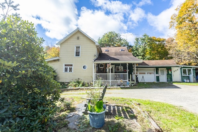 view of front of house with a porch and a garage