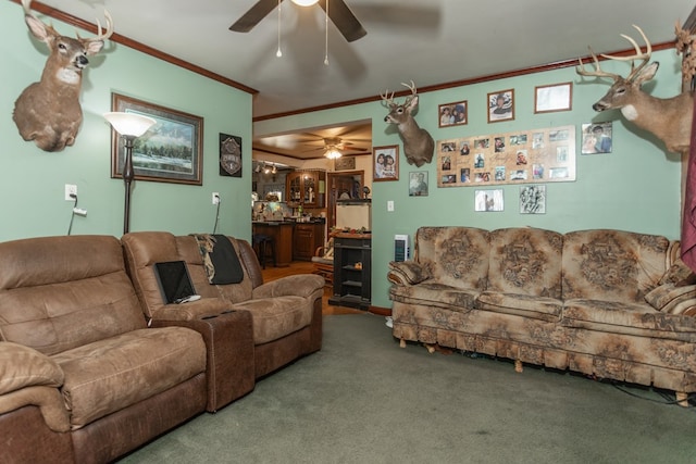 carpeted living room with ceiling fan and ornamental molding