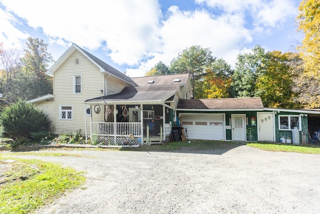 view of front of home featuring covered porch and a garage