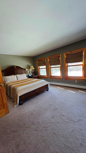 bedroom featuring a baseboard heating unit and carpet