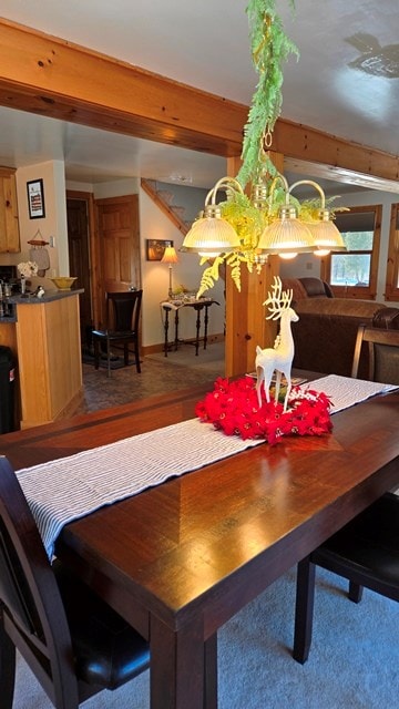 dining area featuring beamed ceiling