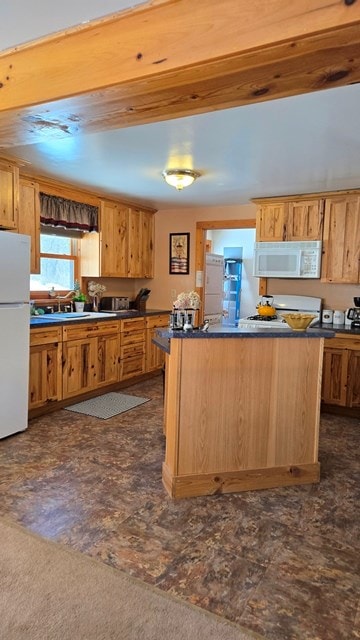 kitchen featuring white appliances and kitchen peninsula