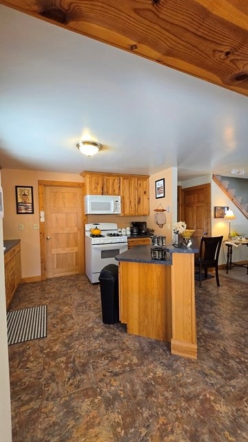 kitchen featuring white appliances and kitchen peninsula