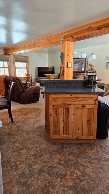 kitchen with beamed ceiling and kitchen peninsula