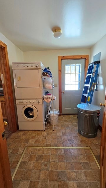 washroom featuring stacked washer and clothes dryer