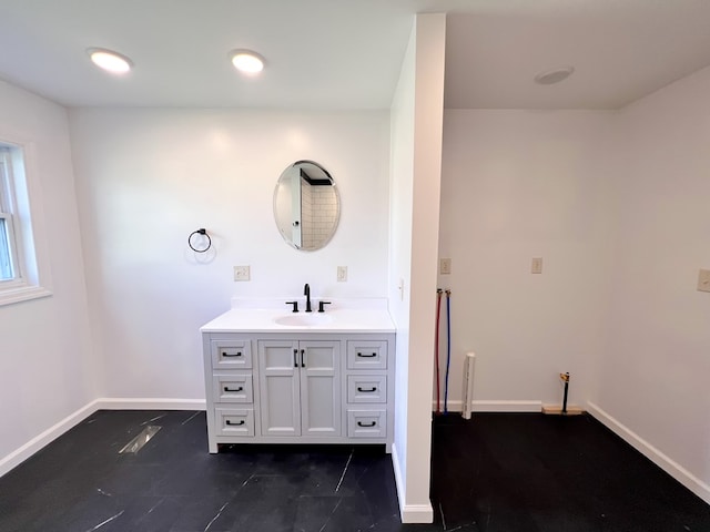 bathroom with vanity and baseboards