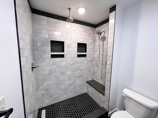 full bathroom with toilet and tiled shower