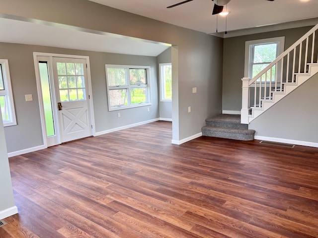 foyer with a wealth of natural light, stairway, and wood finished floors