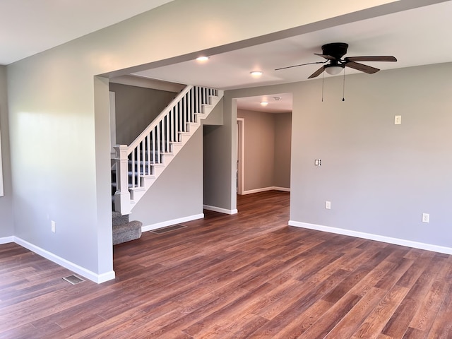 unfurnished room featuring stairs, baseboards, and dark wood-style flooring