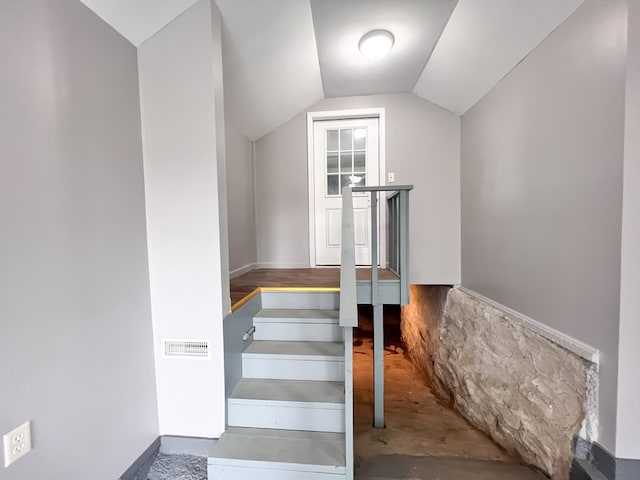 staircase with lofted ceiling