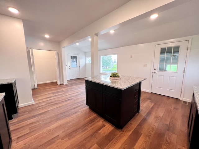 kitchen featuring recessed lighting, dark cabinetry, and light wood-style floors