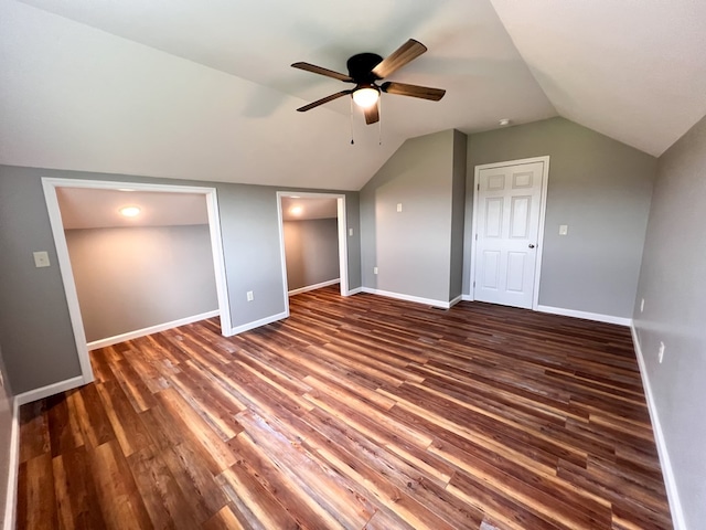 unfurnished bedroom featuring vaulted ceiling, wood finished floors, baseboards, and ceiling fan