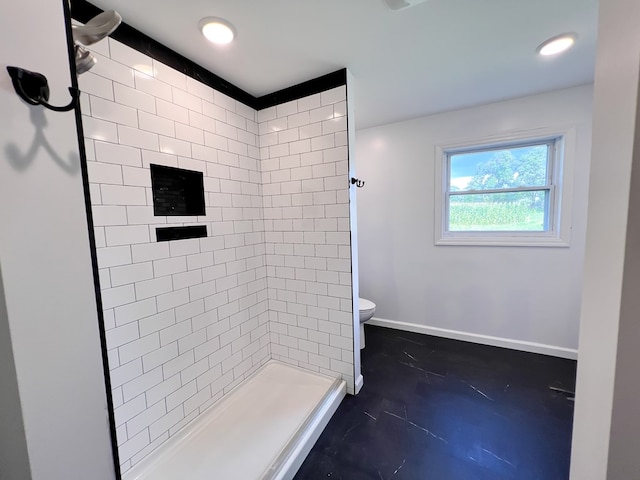 bathroom featuring baseboards, toilet, concrete floors, and a stall shower