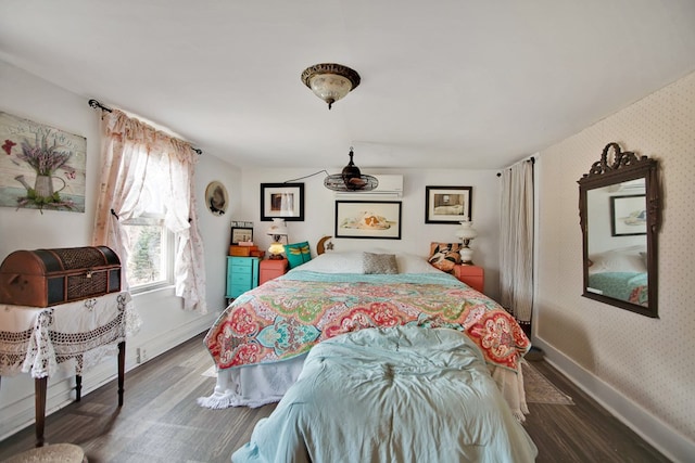 bedroom with wood finished floors, baseboards, and wallpapered walls