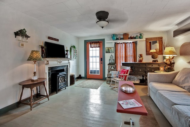 living area featuring baseboards and hardwood / wood-style flooring